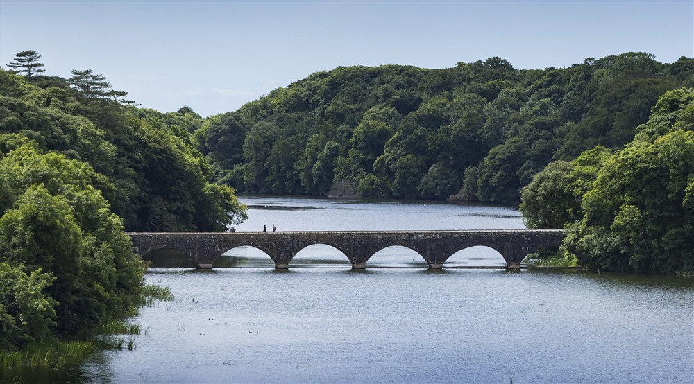 A view of Eight Arch Bridge over the Fish Pond at Stackpole Manor House in Pembroke, Pembrokeshire