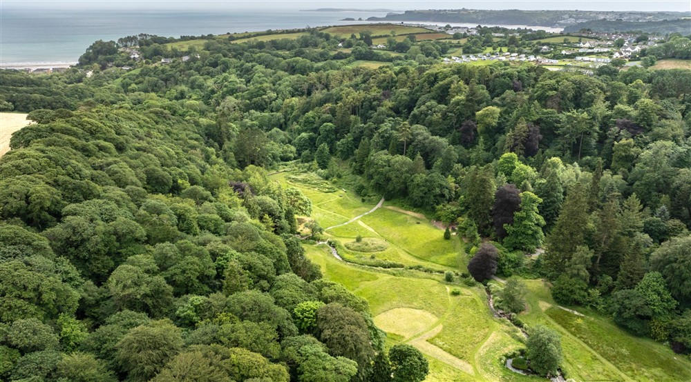 Aerial view of Colby Woodland Garden with coast in the distance at Stackpole Manor House in Pembroke, Pembrokeshire