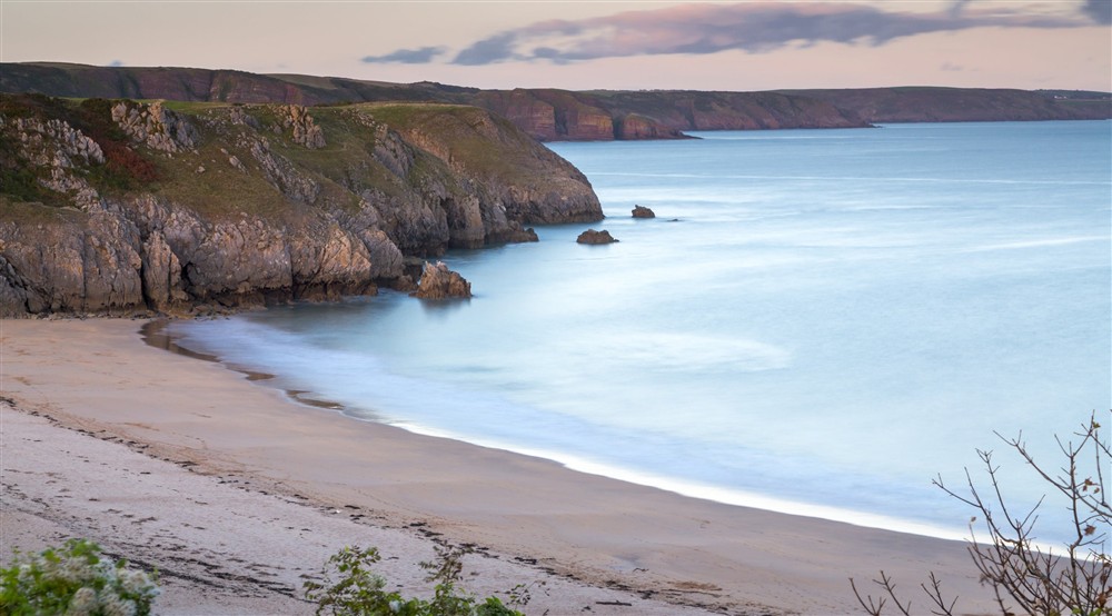 View of calm and tranquil sea on a  spring day Barafundle Bay beach at Stackpole Manor House in Pembroke, Pembrokeshire