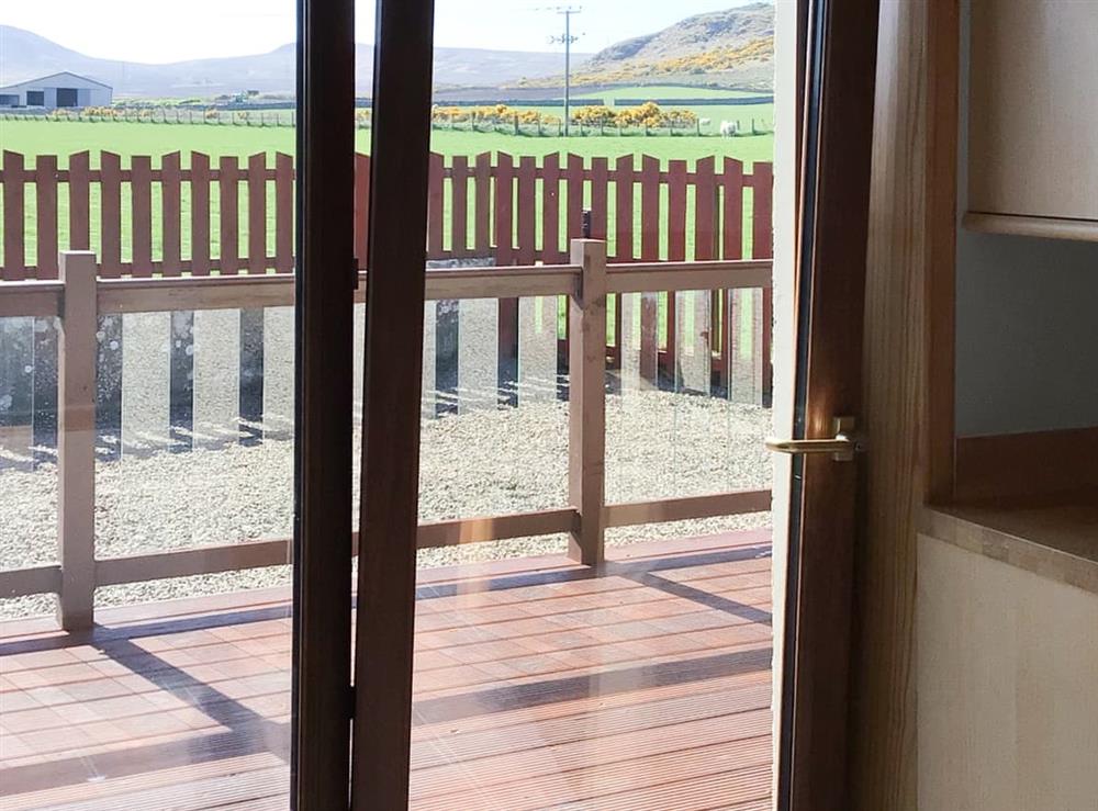 Kitchen patio doors leading to decking at Stackyard Cottage in Reay, Caithness