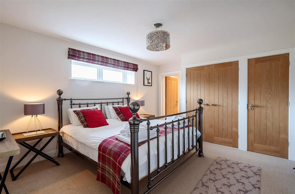 Bedroom one, with an en-suite bathroom at Stags Retreat, Sherborne