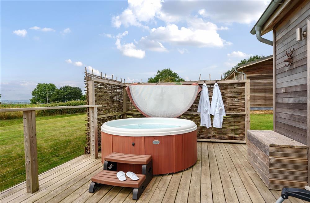 The hot tub with cosy bath robes and slippers at Stags Retreat, Sherborne