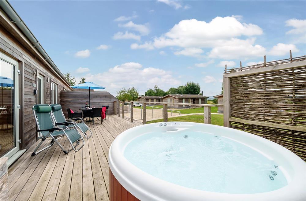 The sundeck complete with garden furniture, hot tub and sun loungers at Stags Retreat, Sherborne