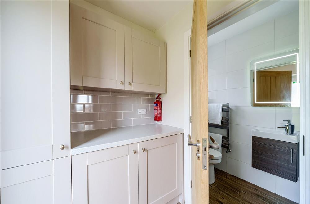 The utility room with walk-in shower room and access to the sun deck at Stags Retreat, Sherborne