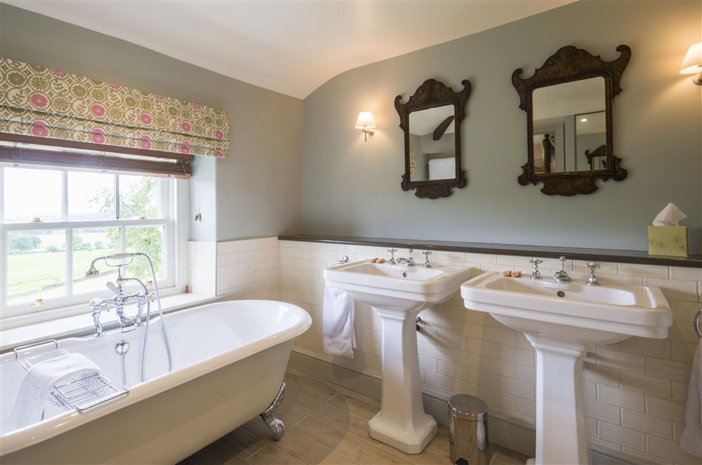 Bedroom two’s en-suite bathroom, with beautiful roll-top bath and handheld shower attachment at Stank House Farm, Skipton