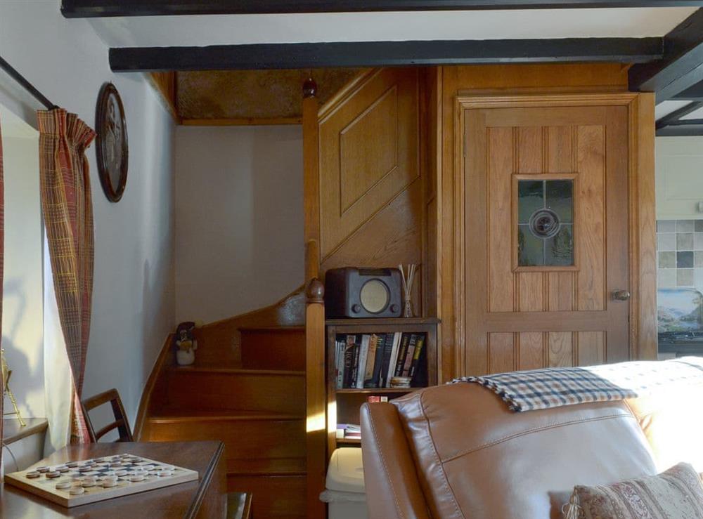 Exposed wood beams throughout with stairs to bedroom at Stanton Cottage in Youlgreave, near Bakewell, Derbyshire