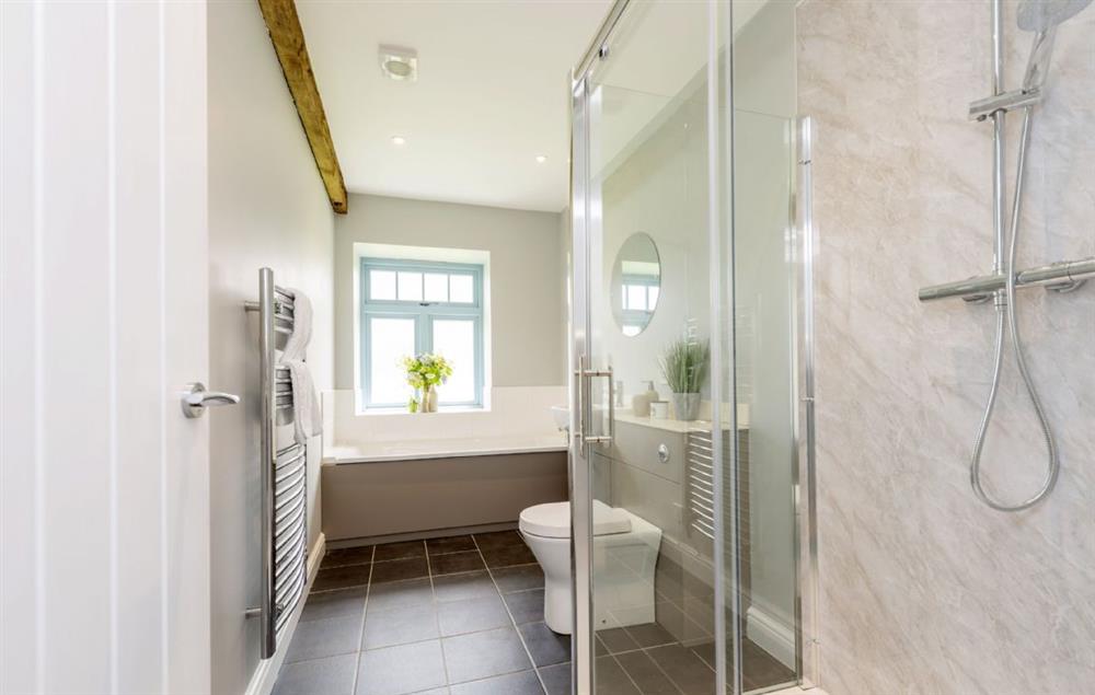 Family bathroom with bath and walk-in shower at Stapleford Farm Cottages, Hooke
