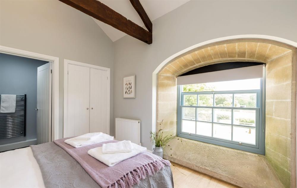 First floor bedroom three with king-size bed and en-suite shower room at Stapleford Farm Cottages, Hooke