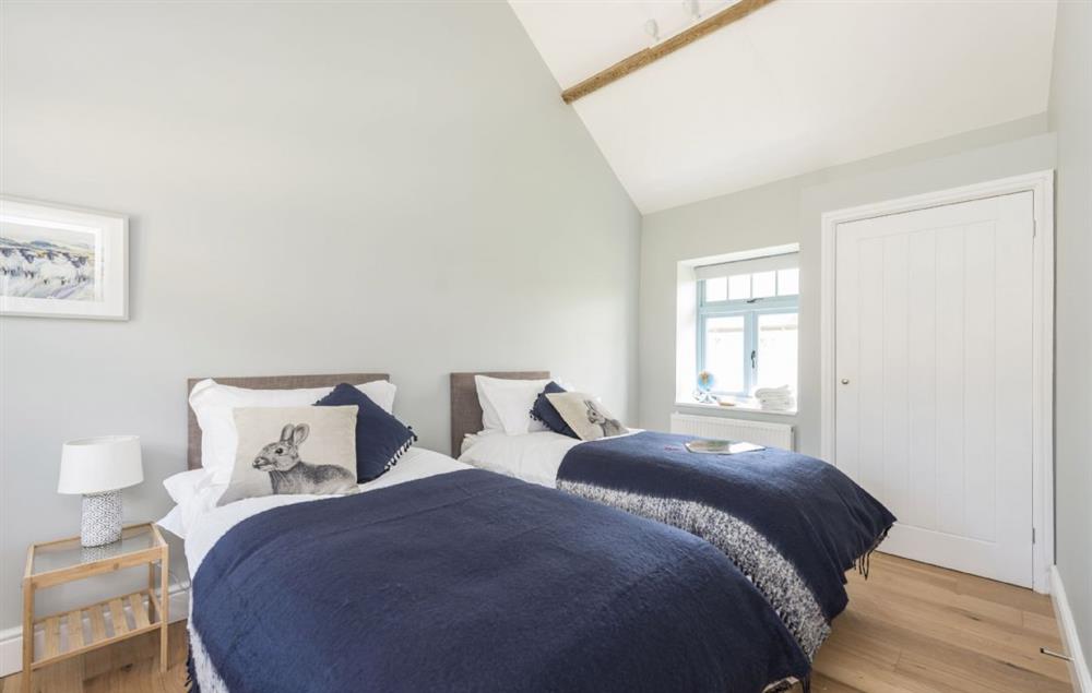 Ground floor bedroom one with twin beds at Stapleford Farm Cottages, Hooke