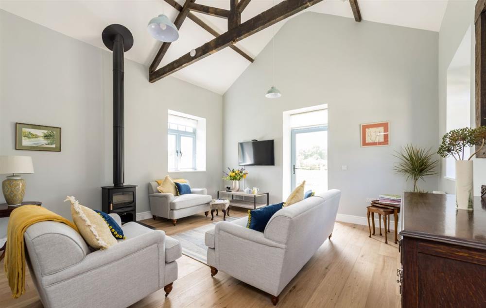 Ground floor sitting room with wood burning stove at Stapleford Farm Cottages, Hooke