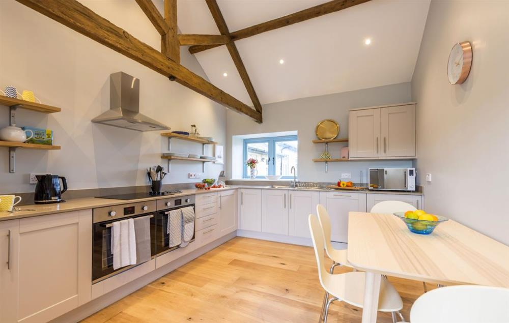 Well-equipped kitchen with table and chairs seating four at Stapleford Farm Cottages, Hooke