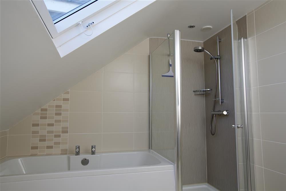 En suite bathroom with additional shower cubicle at Starboard Light in Malborough, Salcombe