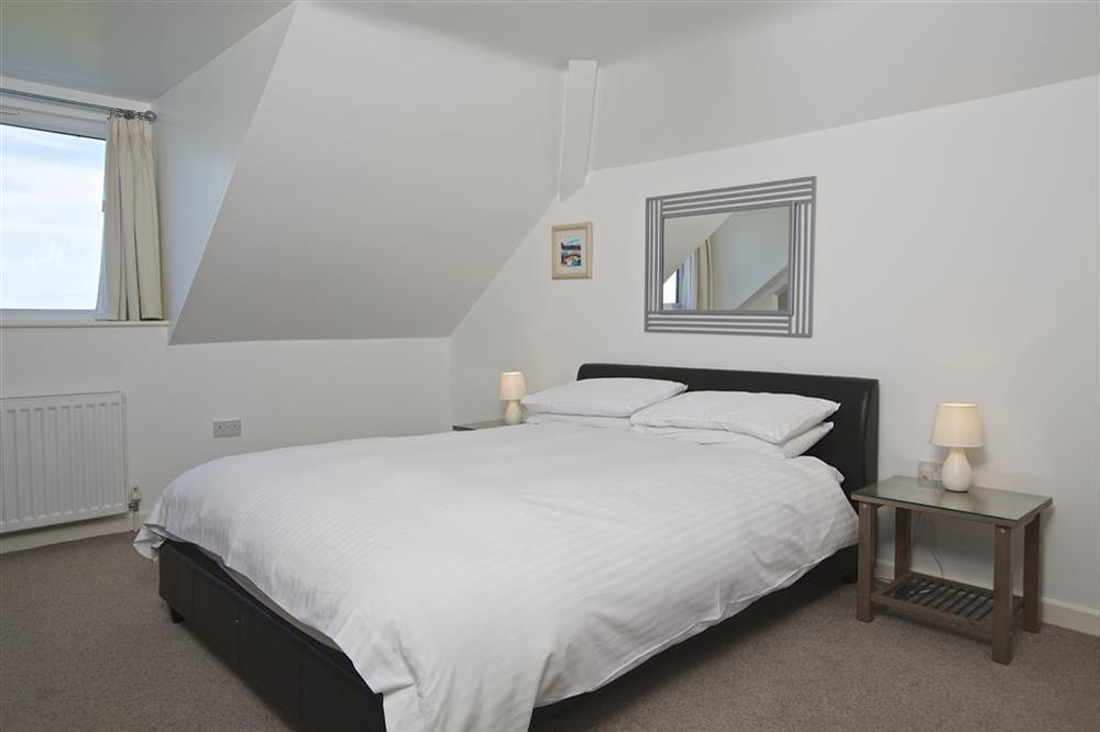 First floor bedroom with King-size bed at Starboard Light in Malborough, Salcombe