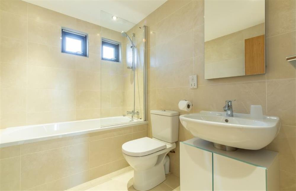 Stargazy, St Agnes. Family bathroom with shower over bath, wash basin and WC at Stargazy, Chapel Porth, St Agnes