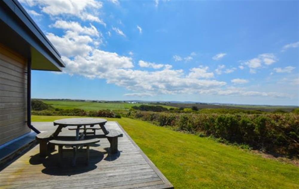 Stargazy, St Agnes. Large decked area with garden furniture and barbecue (photo 3) at Stargazy, Chapel Porth, St Agnes