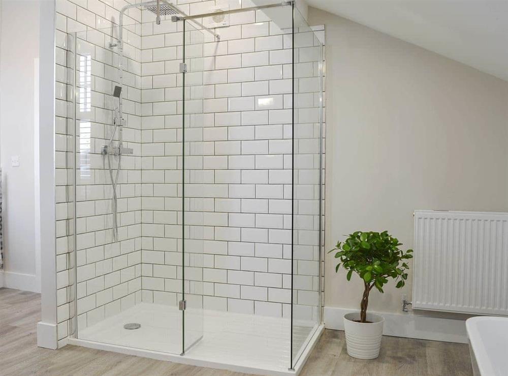 House bathroom features a bath and separate shower cubicle at The Station House, 