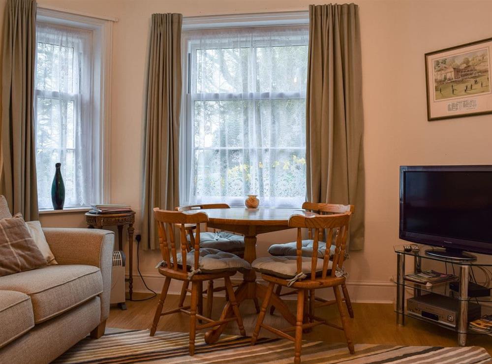 Living room with dining area at Steephill Lodge in Ventnor, Isle of Wight