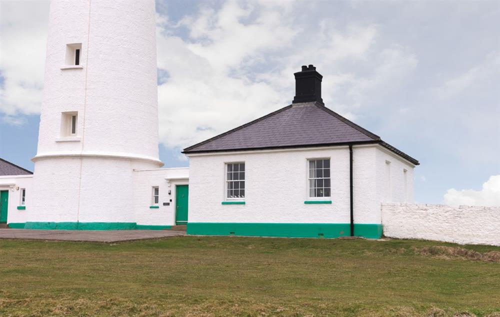 Stella Cottage is to the right hand side of the tower at Stella, Nash Point Lighthouse