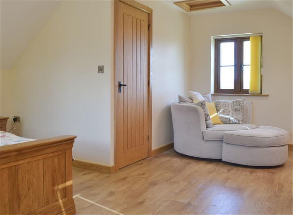 Peaceful double bedroom with seating area at Stepen Cottage, 