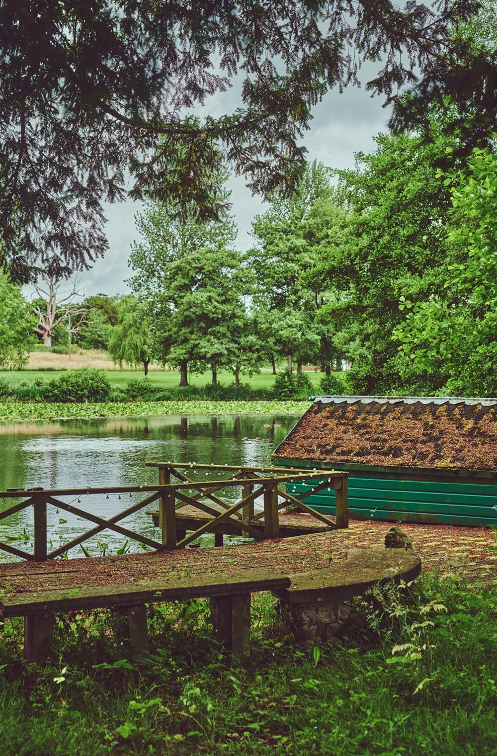 A bench beside the lake and overlooking the estate grounds