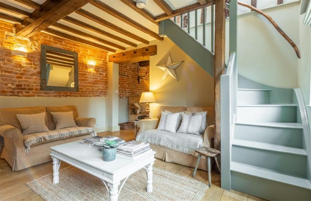 Ground floor: Wooden stairs lead from the sitting room at Stockmans Cottage, Foulsham near Dereham