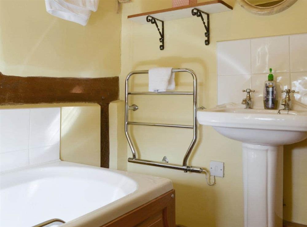 Family bathroom with heated towel rail at Stocks Tree Cottage in Preston Wynne, Herefordshire