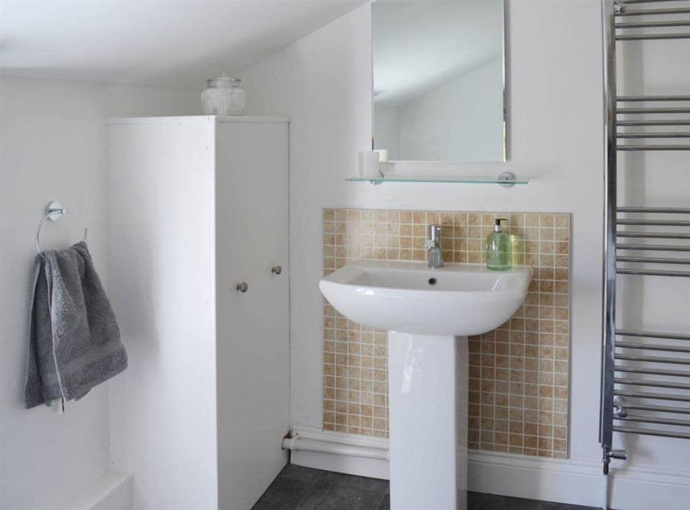The bathroom has sloping ceilings and a heated towel rail at Stockwell Street in Cambridge, Cambridgeshire