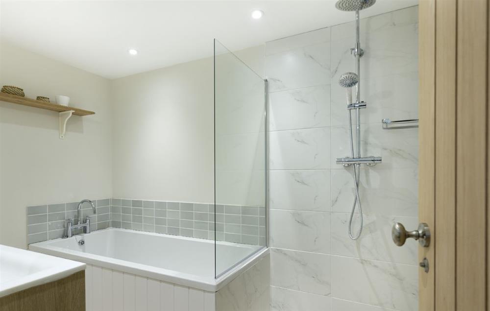A luxury en-suite with bath and walk-in shower at Stone Barn, Upper Swell