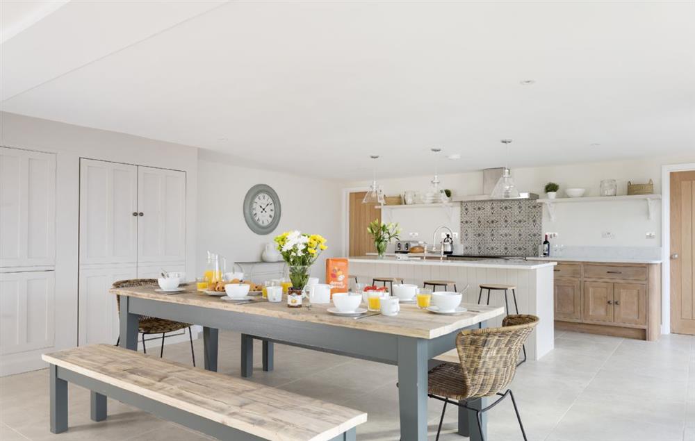 Open-plan kitchen with dining table and seating for ten guests at Stone Barn, Upper Swell