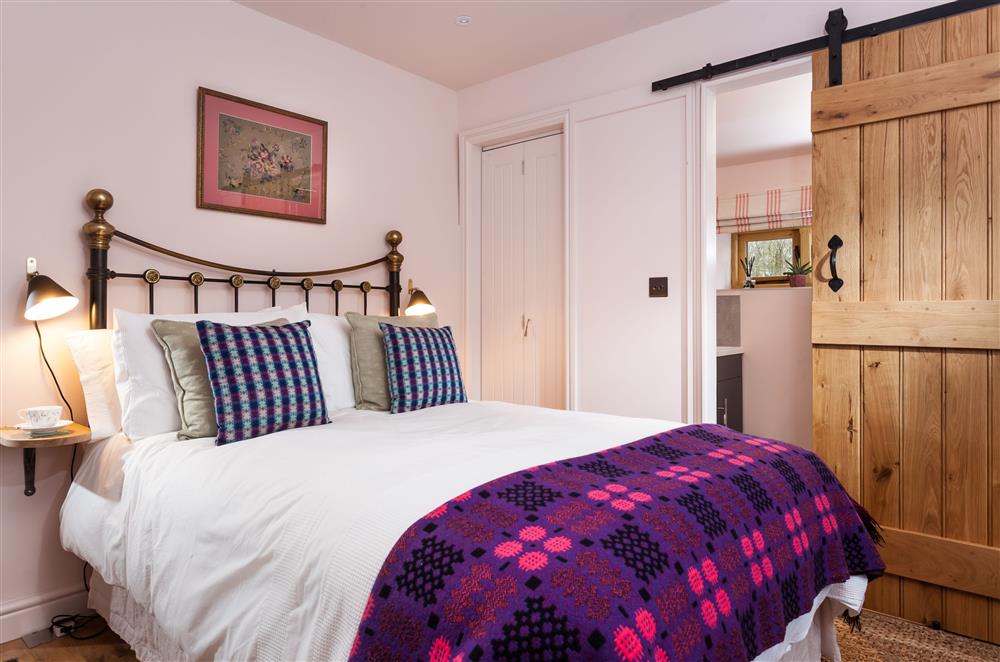 Bedroom one with a 4’6 double bed and en-suite shower room at Stone House, Leominster