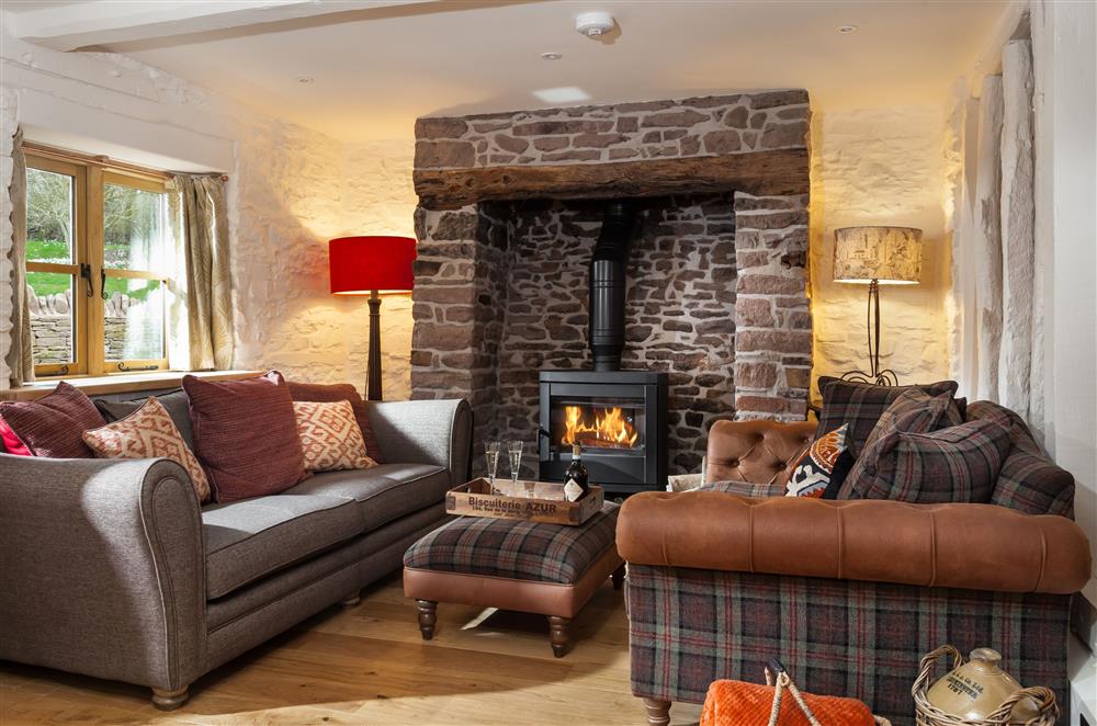Cosy up on the sumptuous sofas by the wood burning stove in the sitting area at Stone House, Leominster