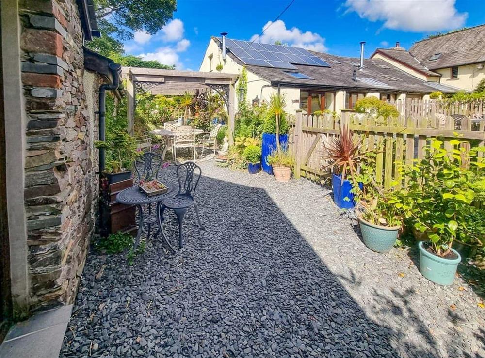Charming seated area with outdoor table and chairs at Stonecroft Cottage in Broughton-in-Furness, near Barrow-in-Furness, Cumbria