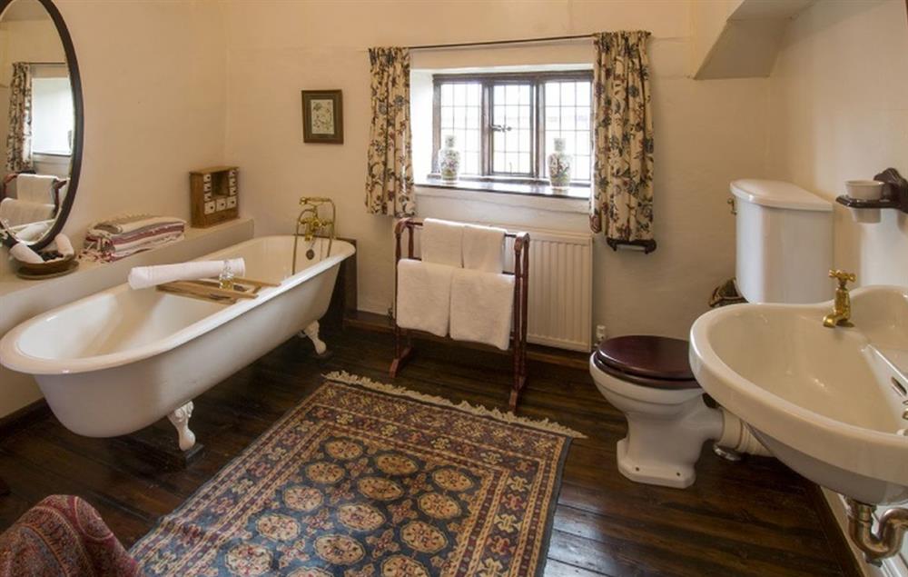 Bathroom with cast iron claw foot bath and handheld shower attachment at Stourton Manor, Stourton