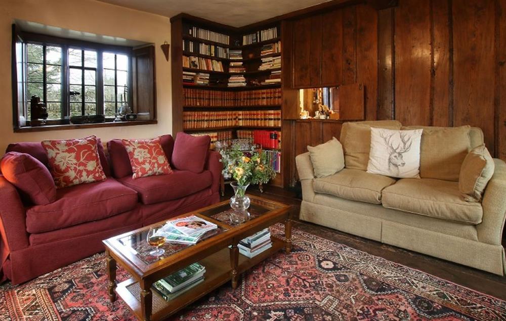 Wood paneled library with double aspect views at Stourton Manor, Stourton