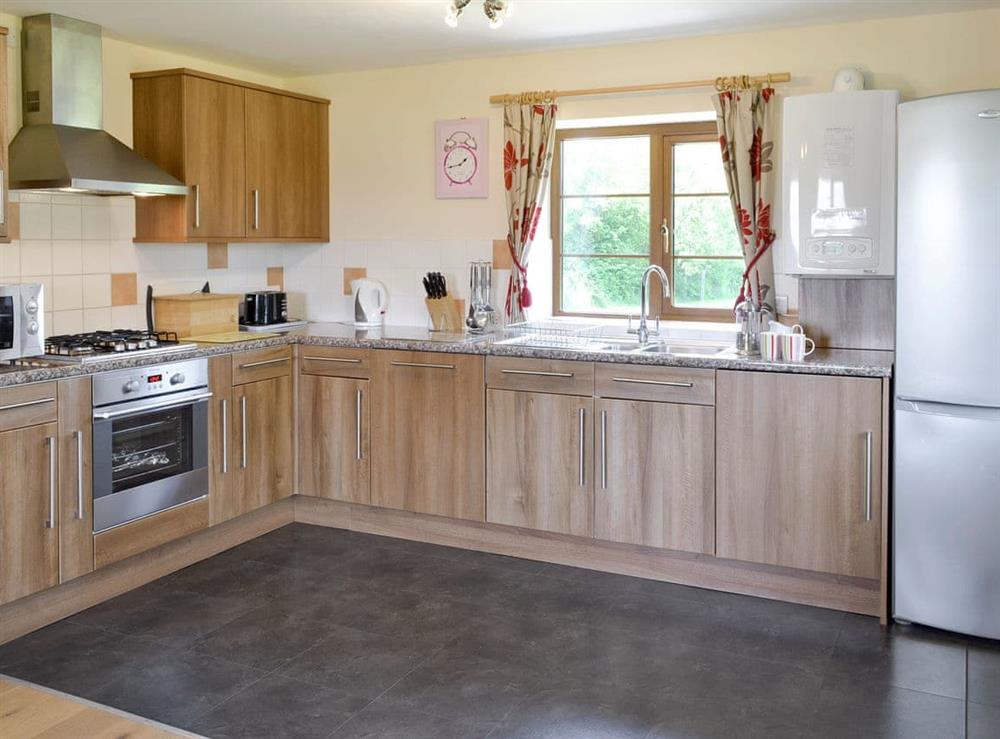 Fully-appointed fitted kitchen area at Tarkas Holt Log Cabin, 