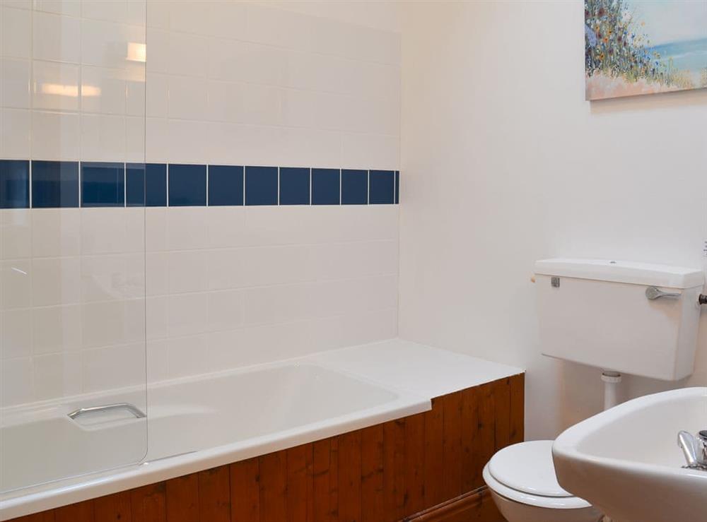 Family bathroom with shower over bath at Tarquol Cottage, 