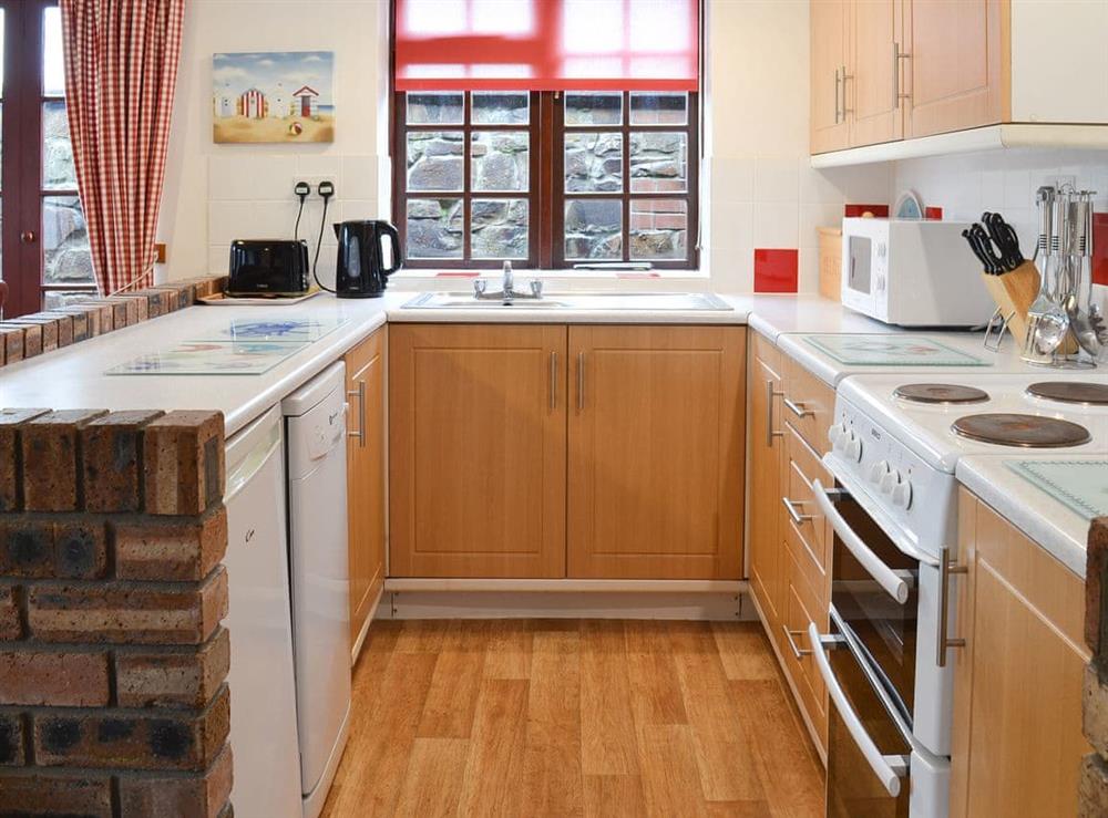 Fully-appointed kitchen area at Tarquol Cottage, 