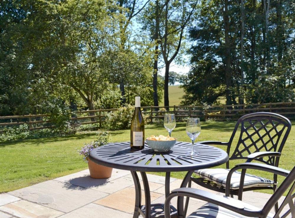 Enjoy a nice glass of wine in the enclosed garden at Curlew Cottage, 