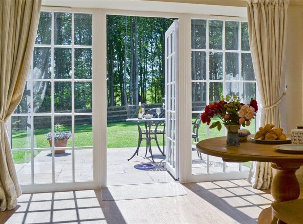French doors from the dining area leading onto the patio at Curlew Cottage, 
