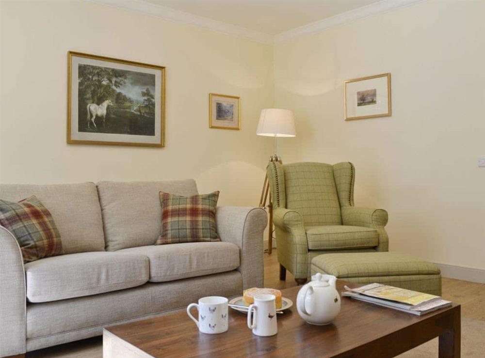 Relax in the charming living room with wood-burning stove at Curlew Cottage, 
