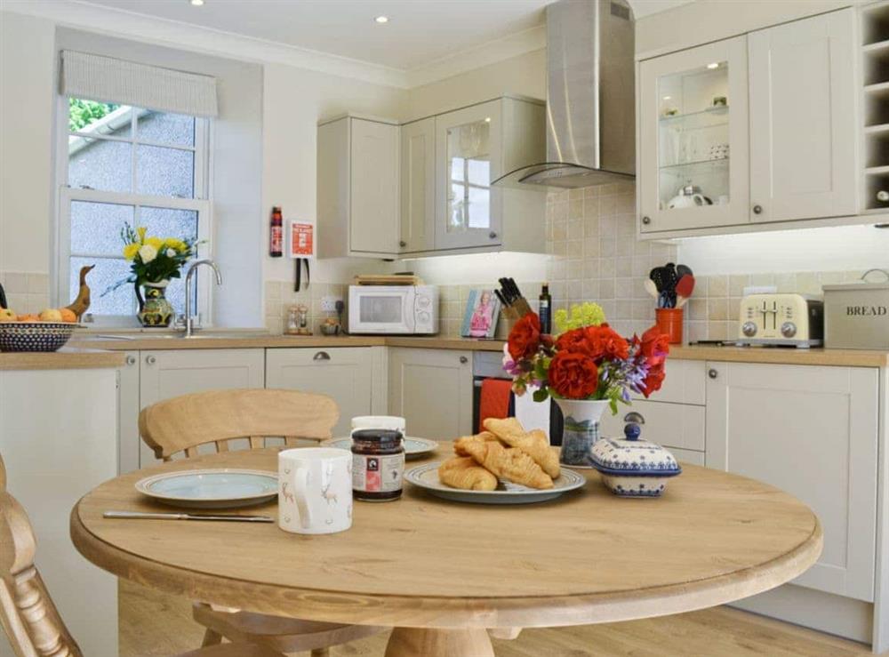 Well-equipped country style kitchen and dining area at Curlew Cottage, 