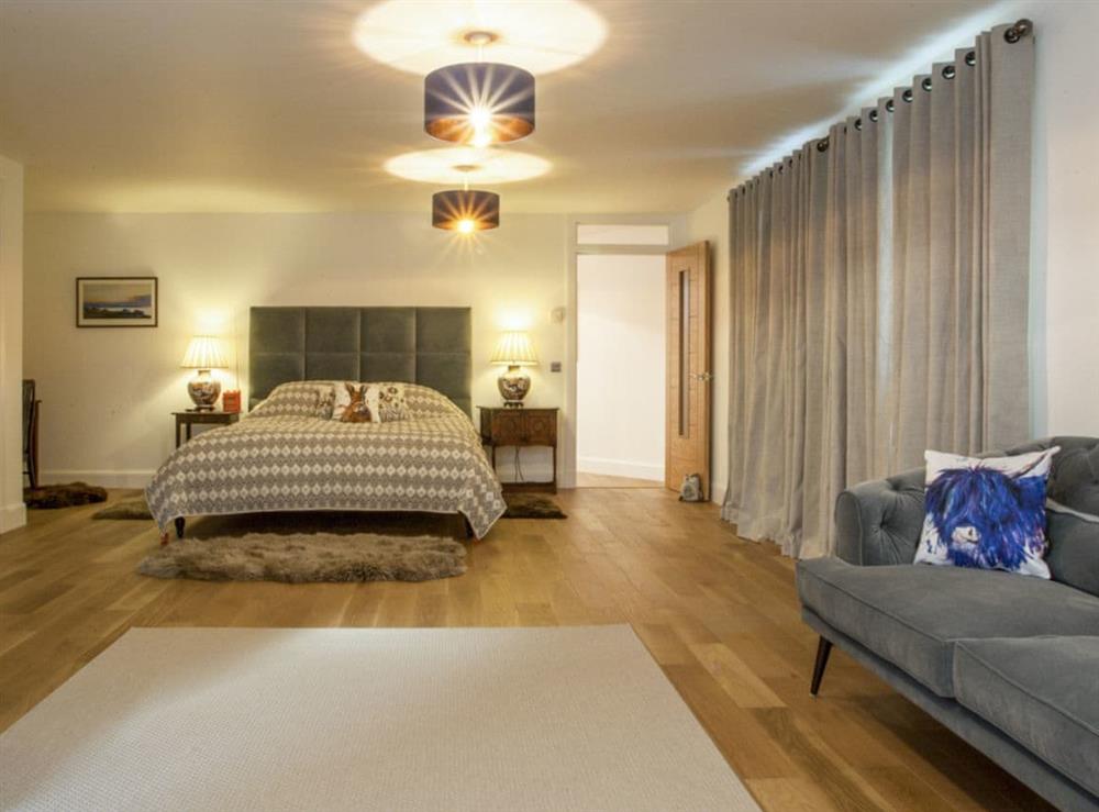 Large master bedroom with seating area and en-suite at Strathspey Lodge in Duthil, Carrbridge, near Aviemore, Highlands, Inverness-Shire