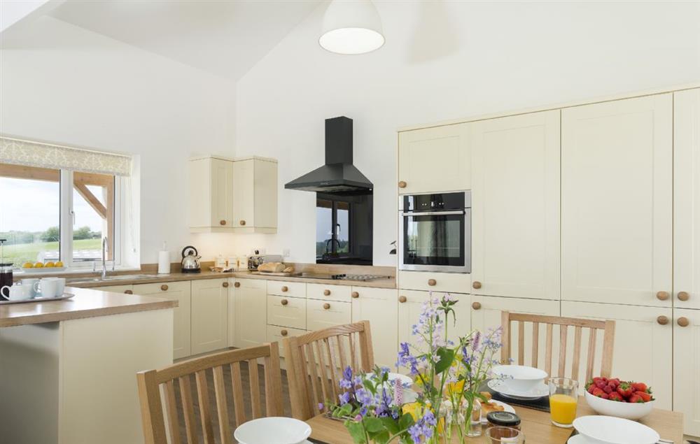 Open plan kitchen, sitting and dining room with French doors to the veranda (photo 2) at Strawberry Lodge, Billesdon