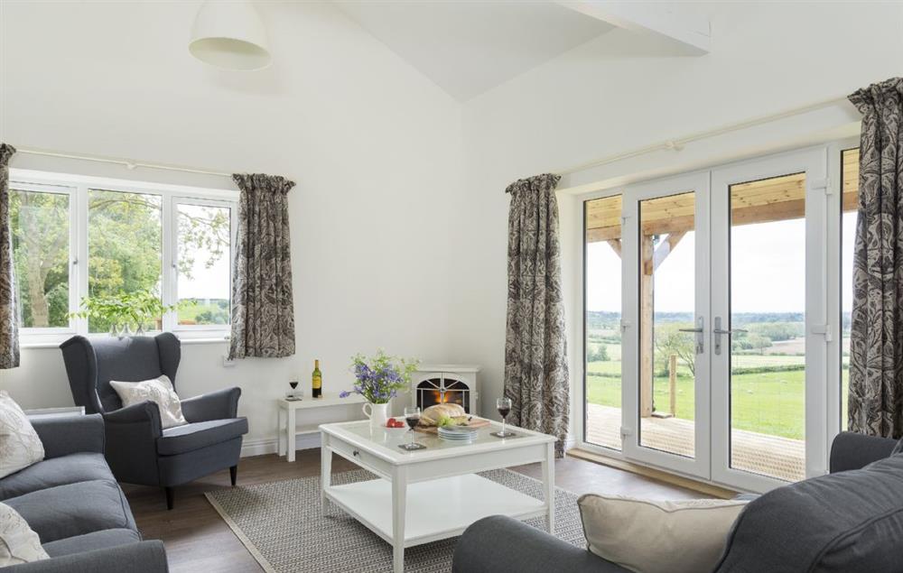Open plan kitchen, sitting and dining room with French doors to the veranda (photo 3) at Strawberry Lodge, Billesdon
