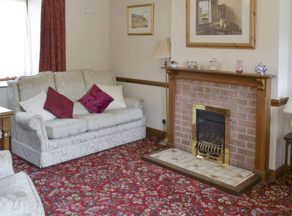 Spacious living room with convenient dining area at Cow Pasture Cottage, 