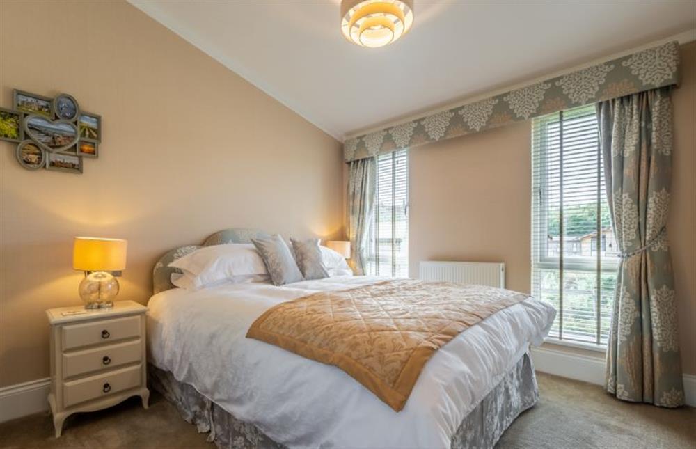Ground floor: Master bedroom with a king-size bed at Suffolk Barn, Kelling near Holt