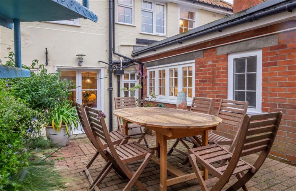 Patio with outdoor furniture and charcoal barbecue at Suffolk House, Aldeburgh