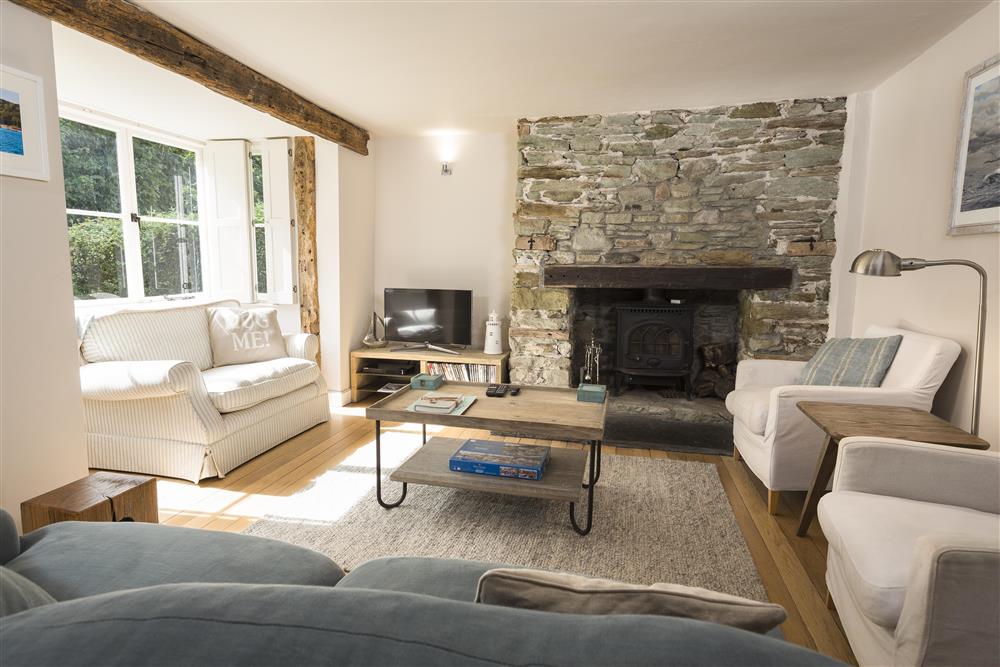 Sitting room with original supporting beams and oak flooring at Summer Cottage in , Salcombe
