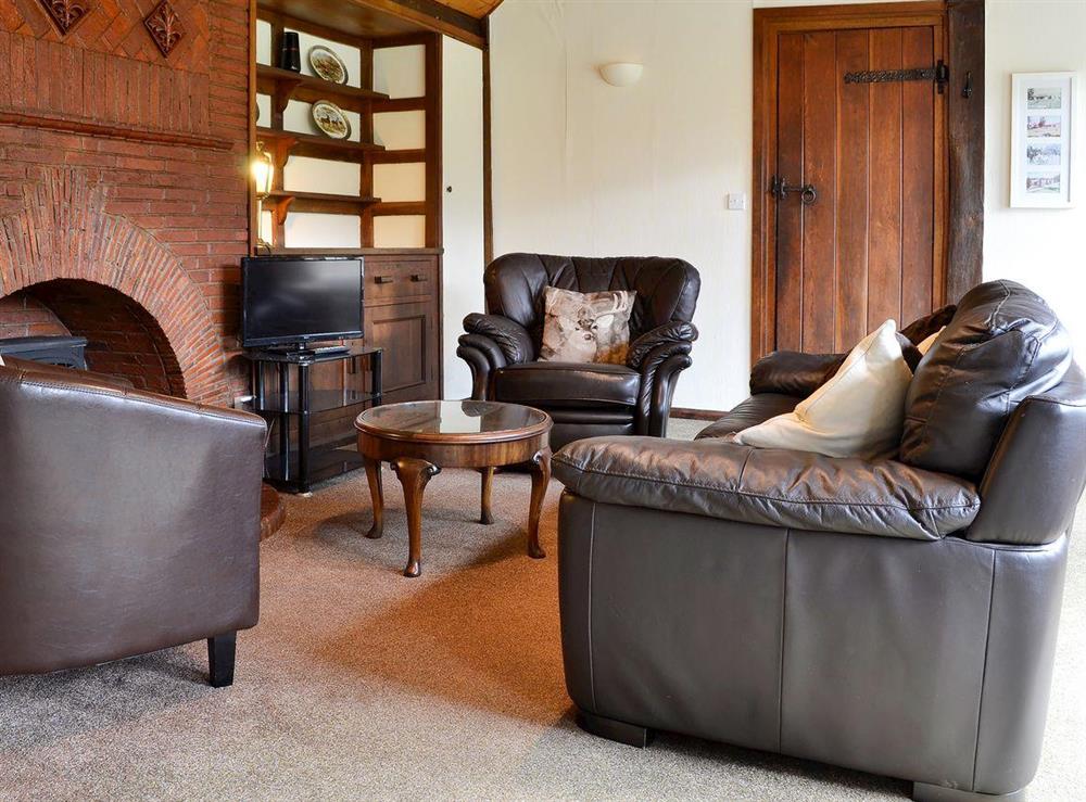 Delightful living room with feature brick fireplace at Summer House in St Asaph, Denbighshire