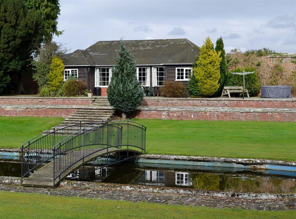 Extensive terraced, lawned gardens and ornamental pond at Summer House in St Asaph, Denbighshire